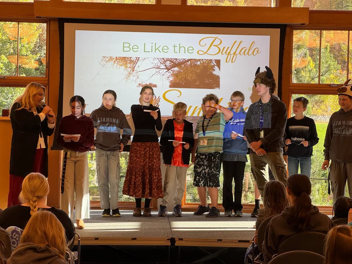 Students presenting on stage during an evening program