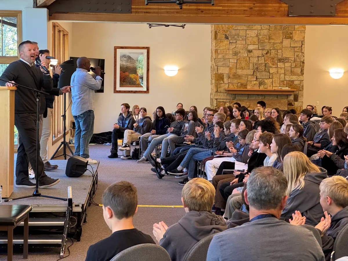 A speaker addressing students gathered in the lodge